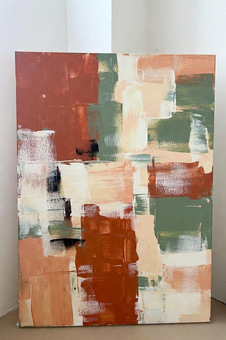 DIY abstract painting large canvas leaning against white wall earth tone brush strokes terracotta cream sage