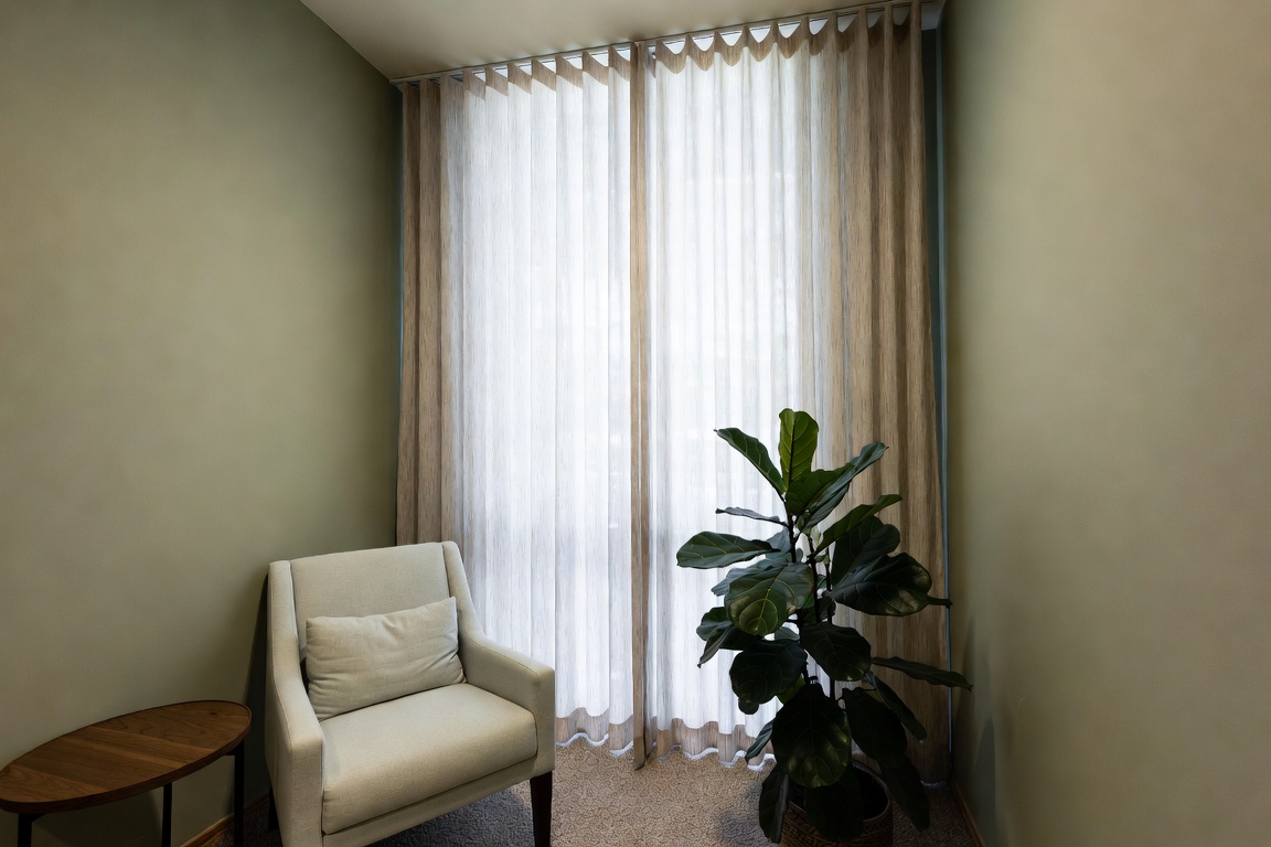 small cozy living room with cream sofa rattan coffee table and large mirror on neutral wall