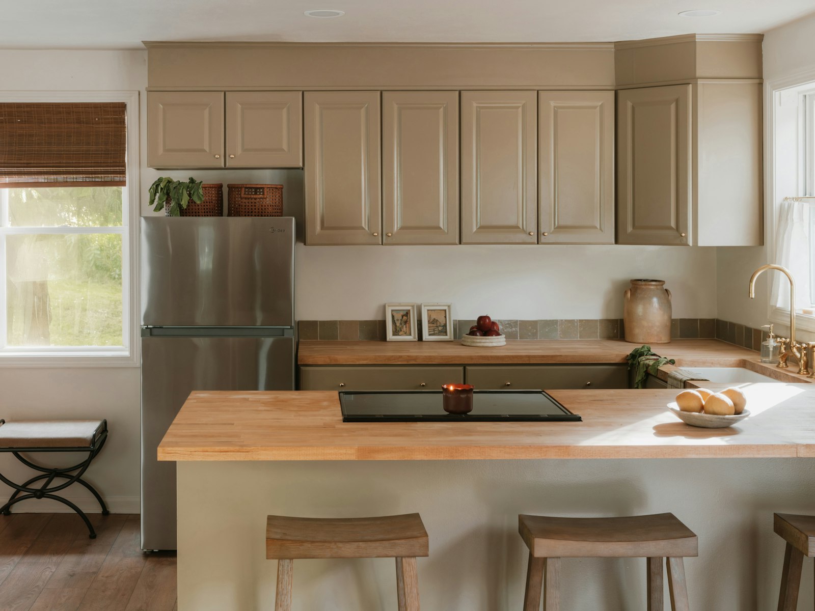 A modern kitchen with light wood countertops and island