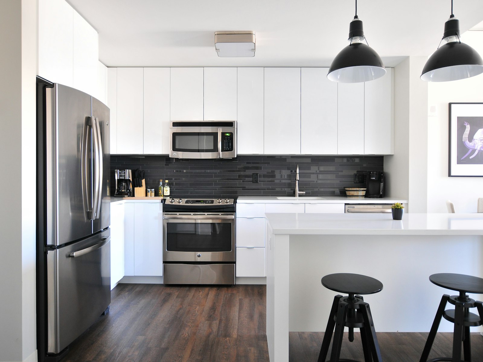 Gray steel 3-door refrigerator near modular kitchen