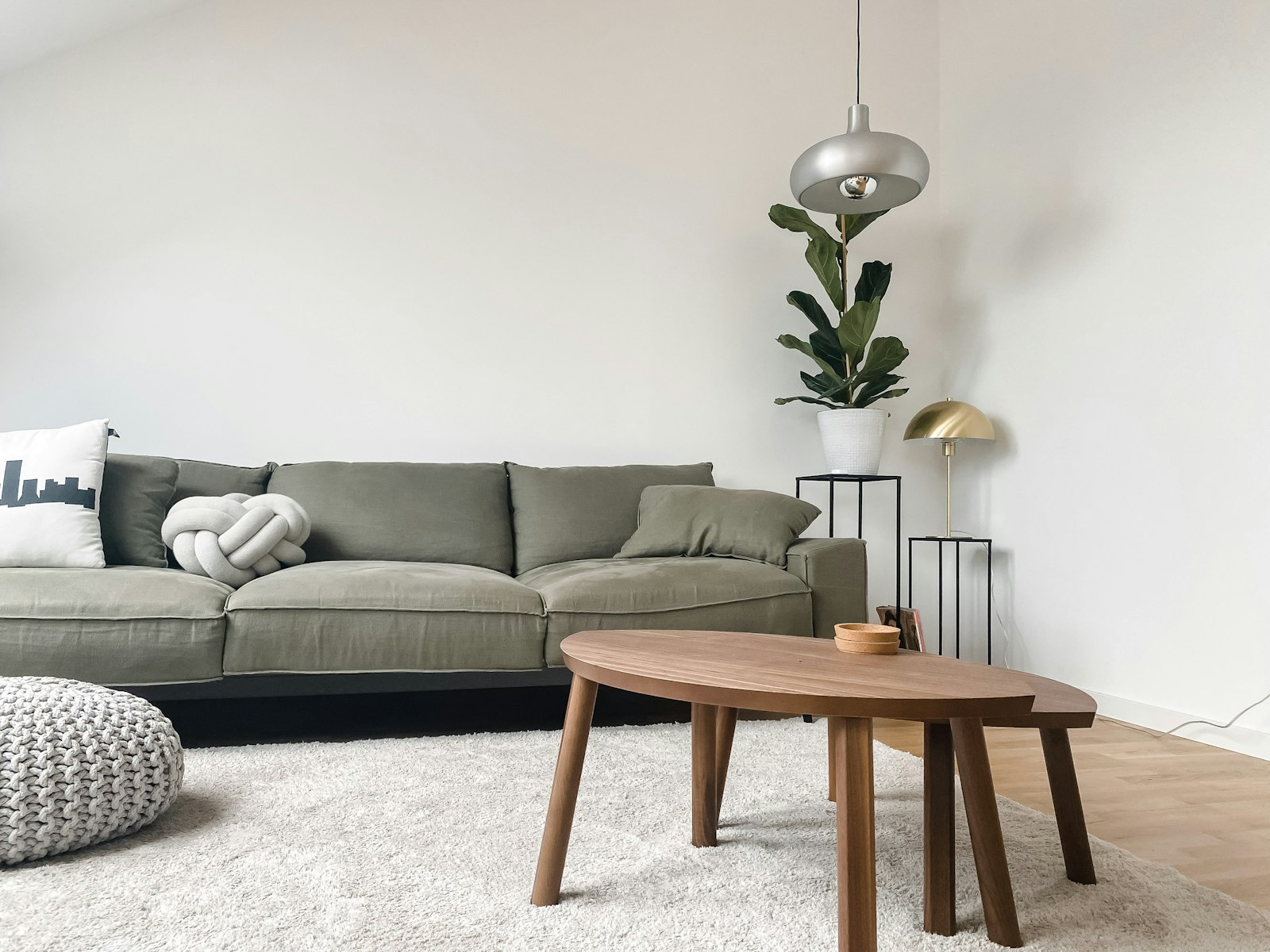 Gray 2 seat sofa near brown wooden coffee table