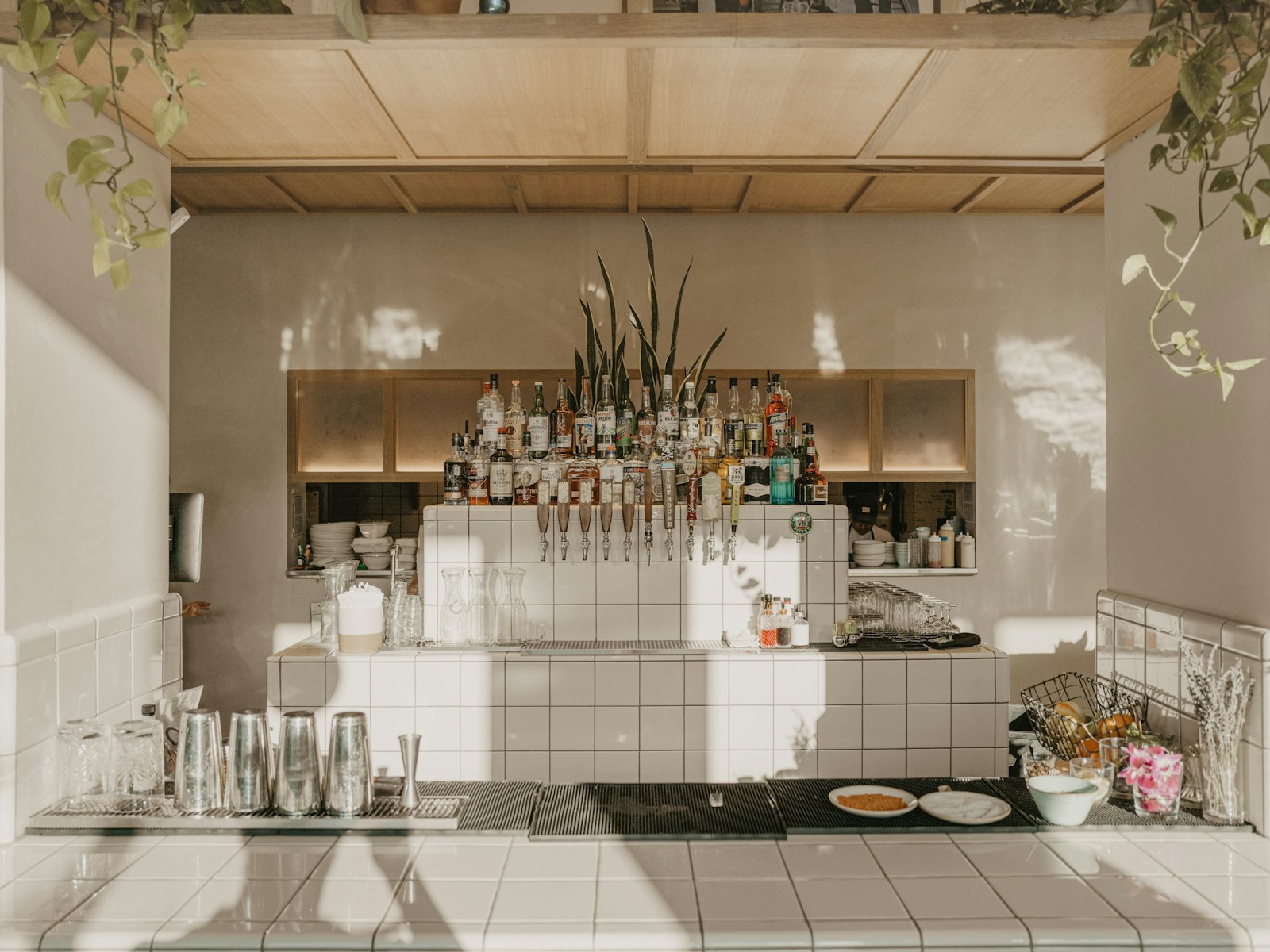 A kitchen with a lot of bottles on the wall