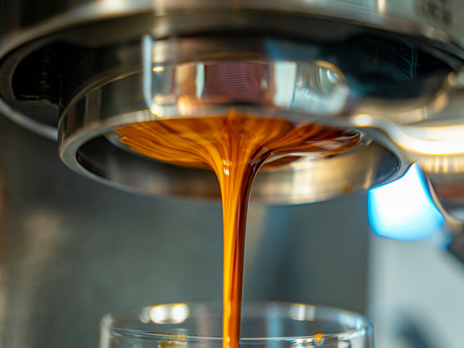 Fresh espresso pouring into a glass