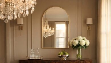 Gold arched mirror above a walnut sideboard in a formal dining room