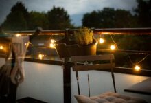 A balcony with a chair and a potted plant on it
