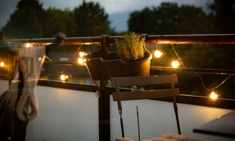 A balcony with a chair and a potted plant on it