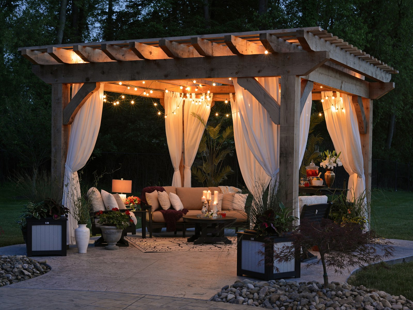 Photo of gazebo with curtain and string lights