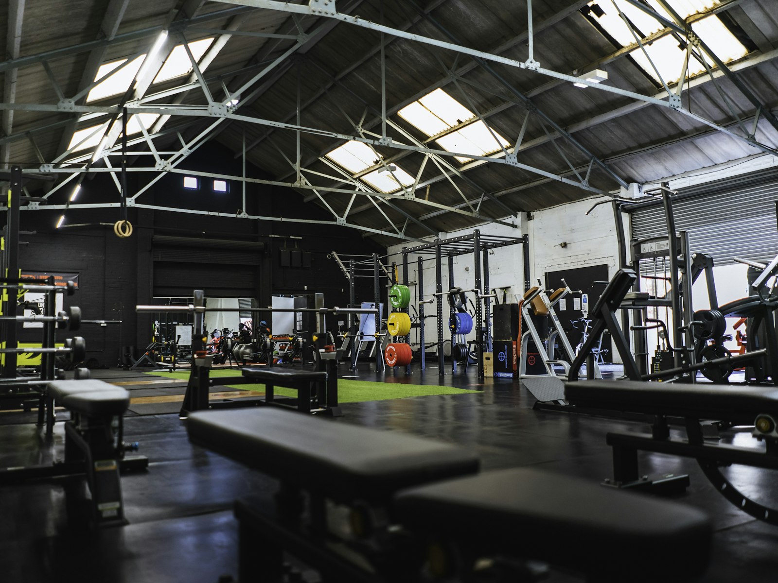 Weightlifting equipment and benches in a spacious gym