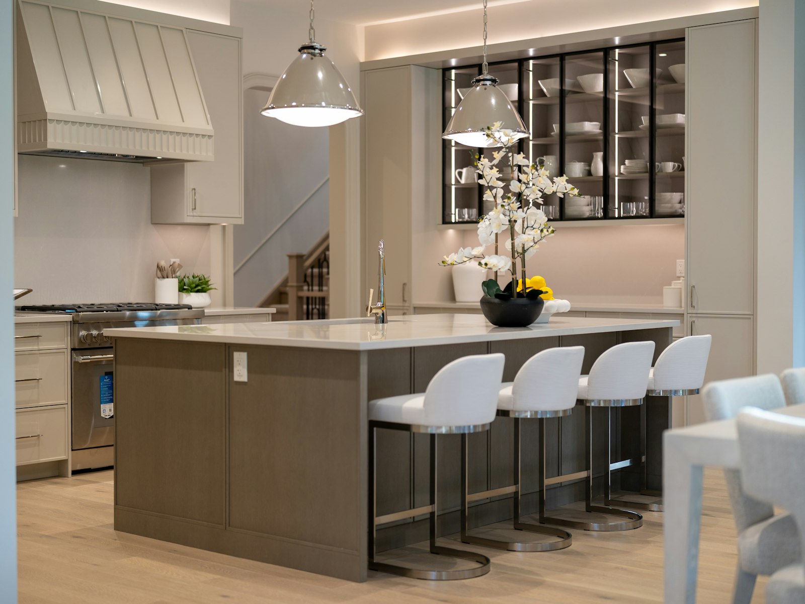 Modern kitchen island with white bar stools