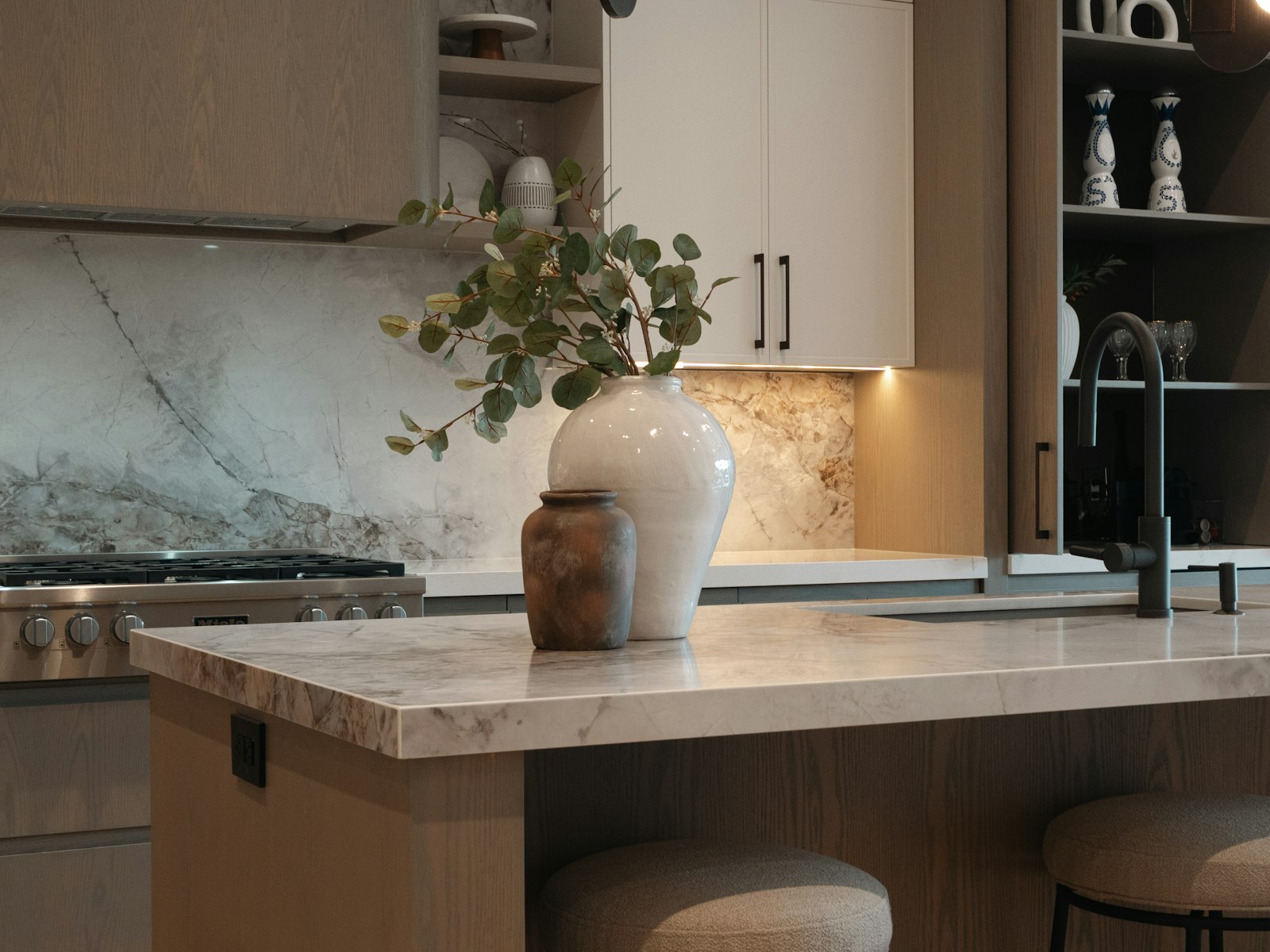 Modern kitchen island with decorative vases and faucet
