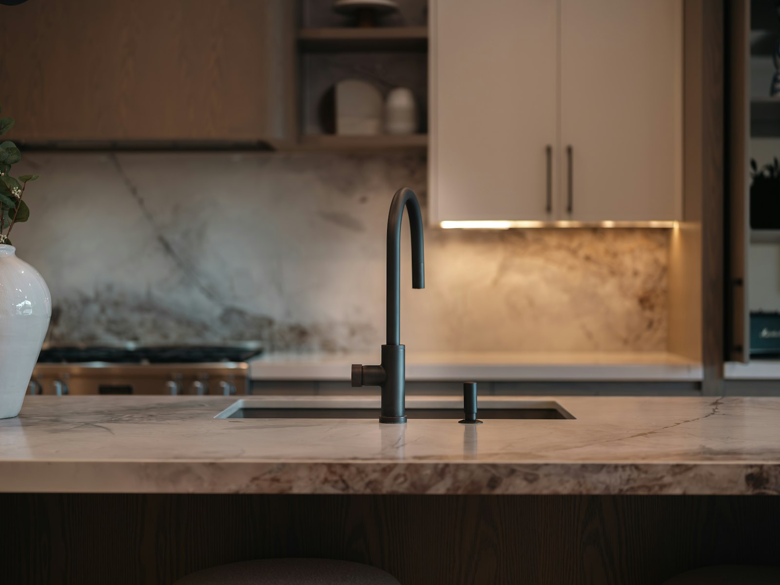Modern kitchen sink with marble countertop and backsplash