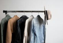 Hat and five jackets hanging on a coat rack