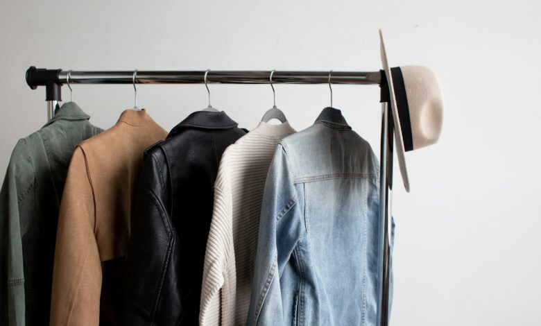 Hat and five jackets hanging on a coat rack