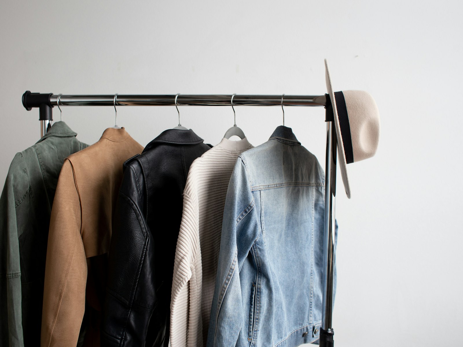 Hat and five jackets hanging on a coat rack