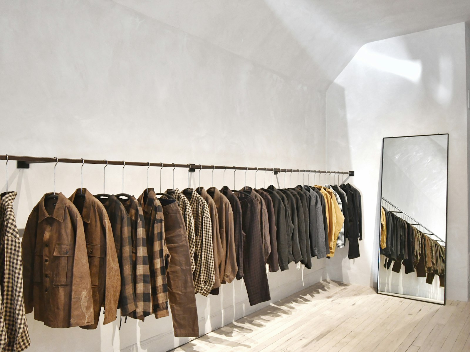 A room with a wall of hanging clothes