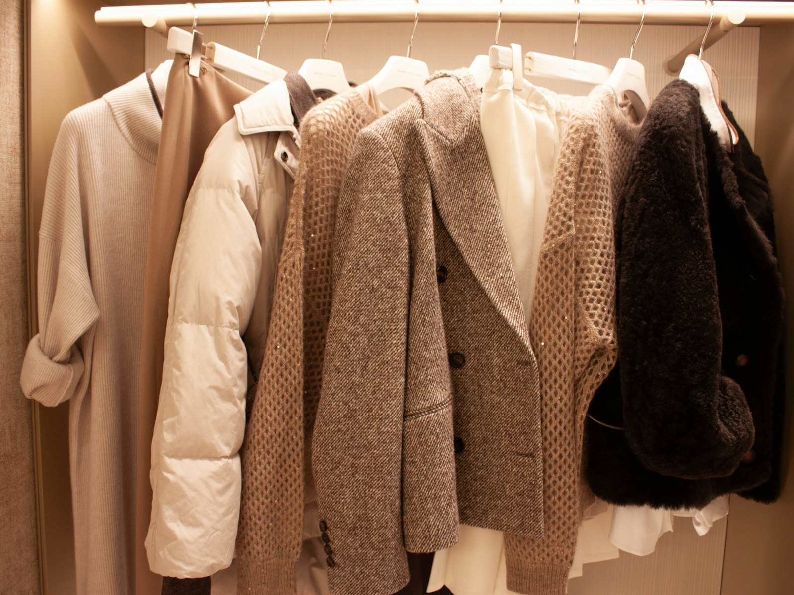 Various coats and jackets hanging on a rack
