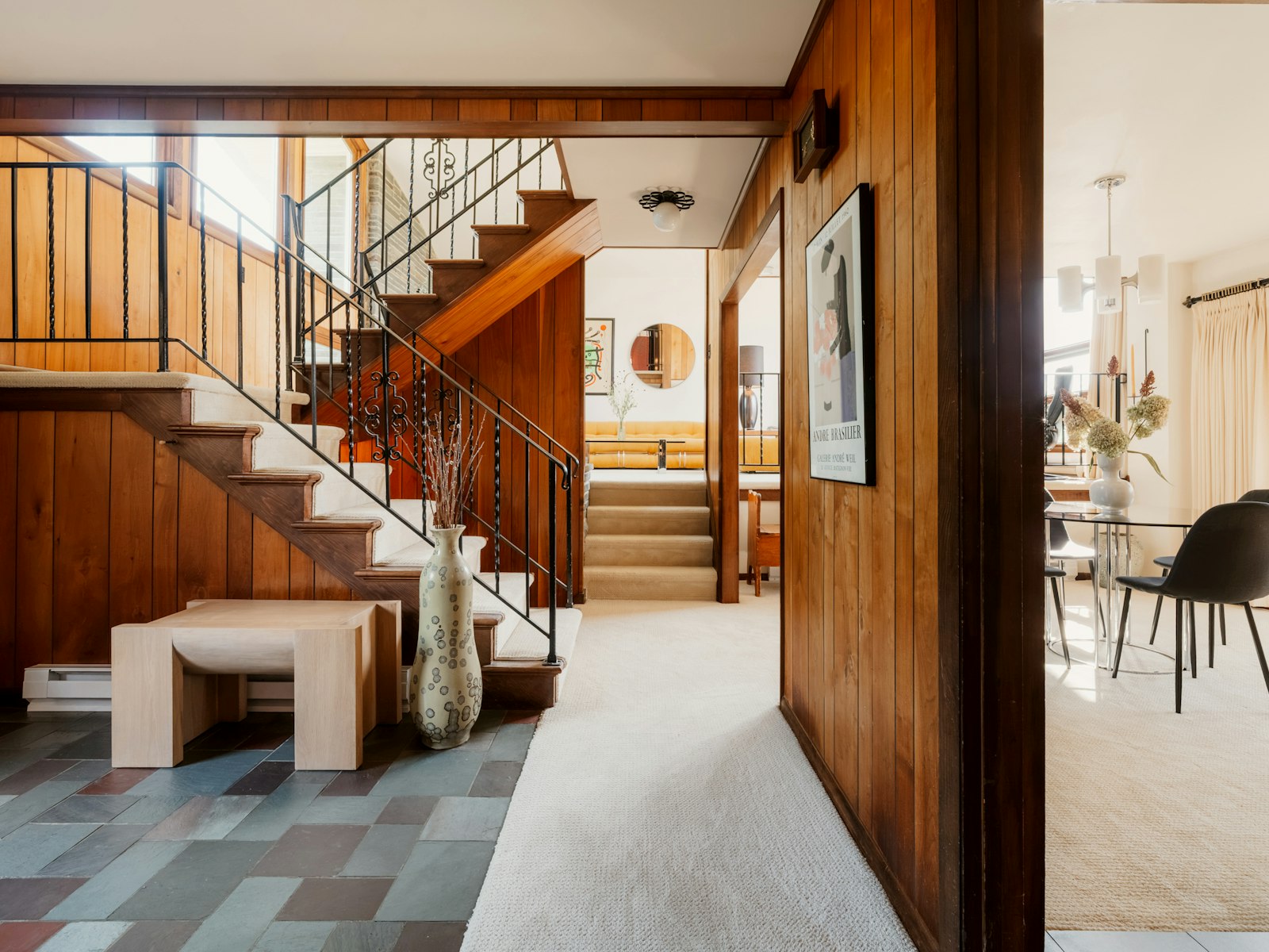 A wooden staircase with iron railings in a mid-century home