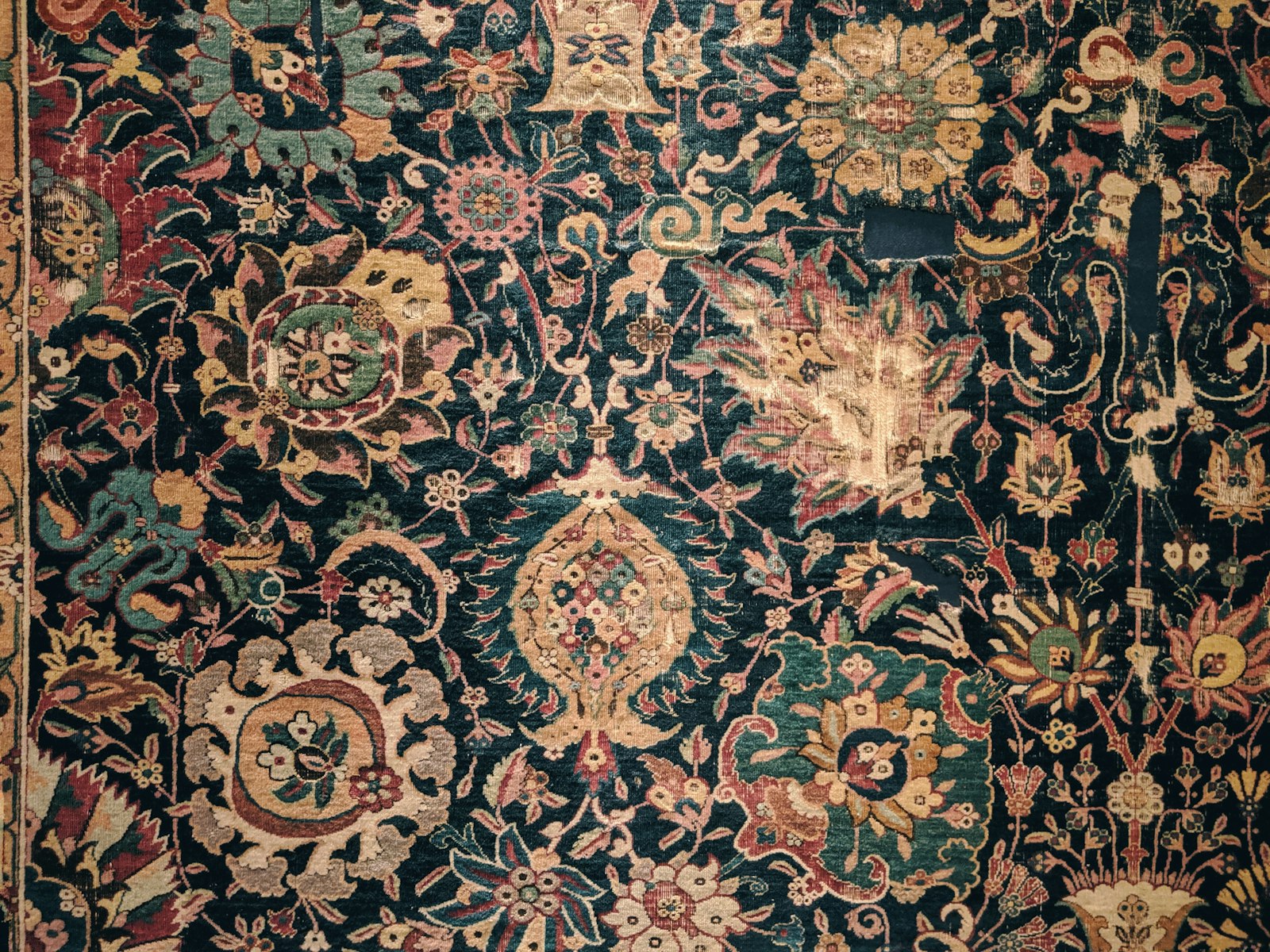 A large rug with many different colors and designs