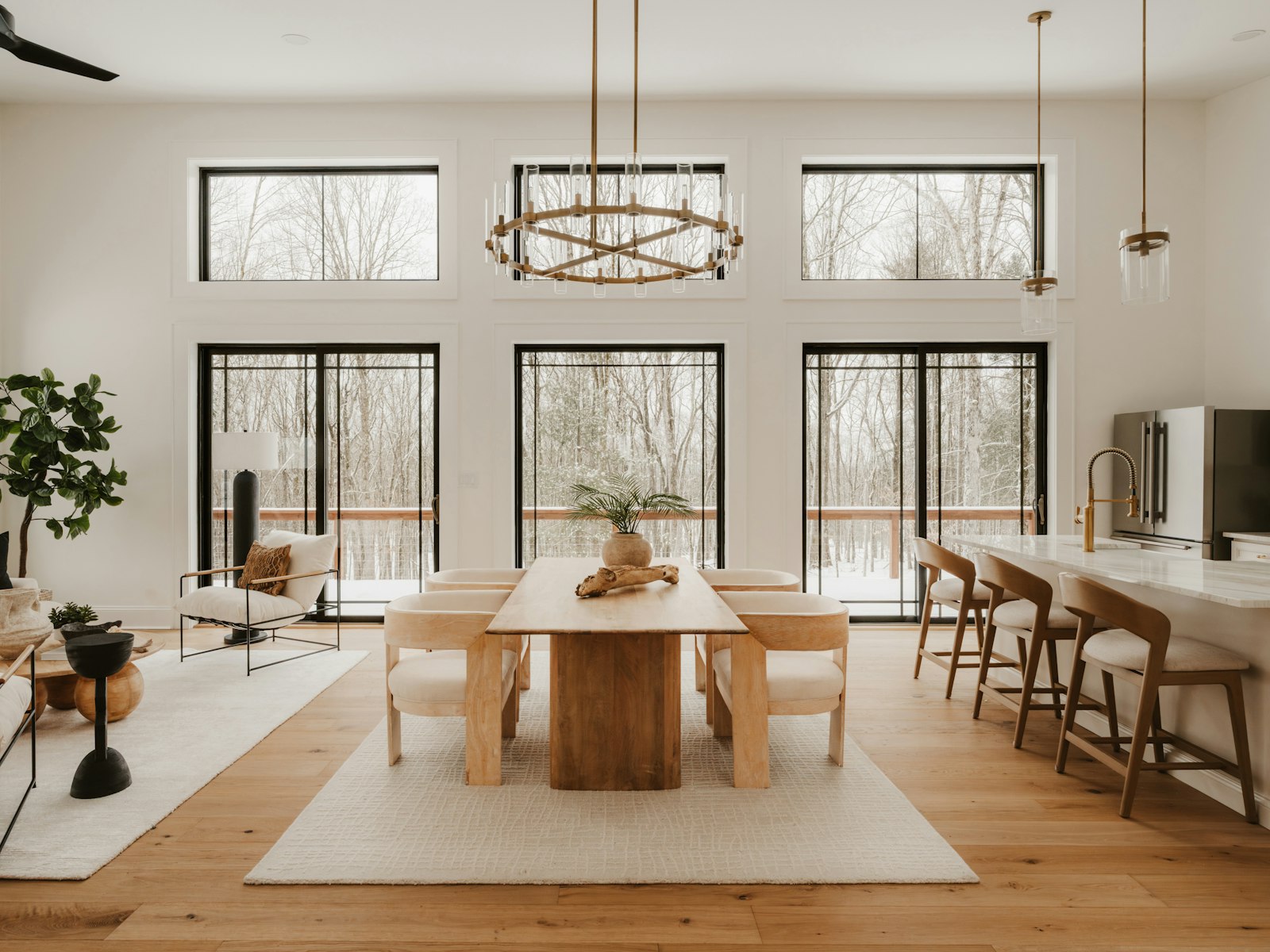 Modern dining and living area with large windows