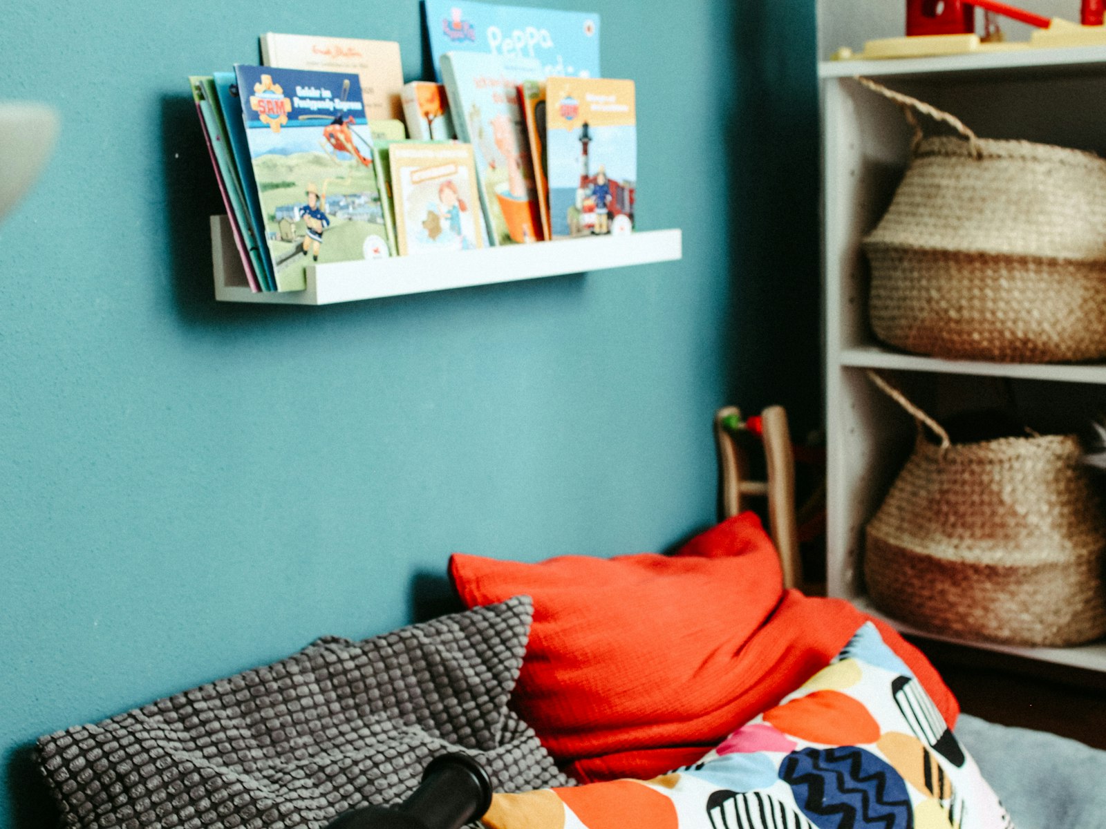 Red pillow on blue and white bed linen