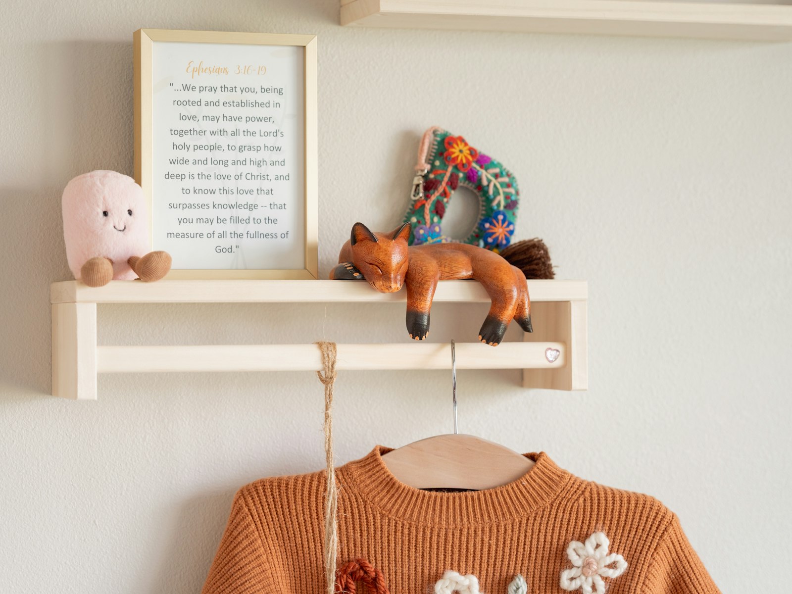 A shelf with decorations and a cozy sweater
