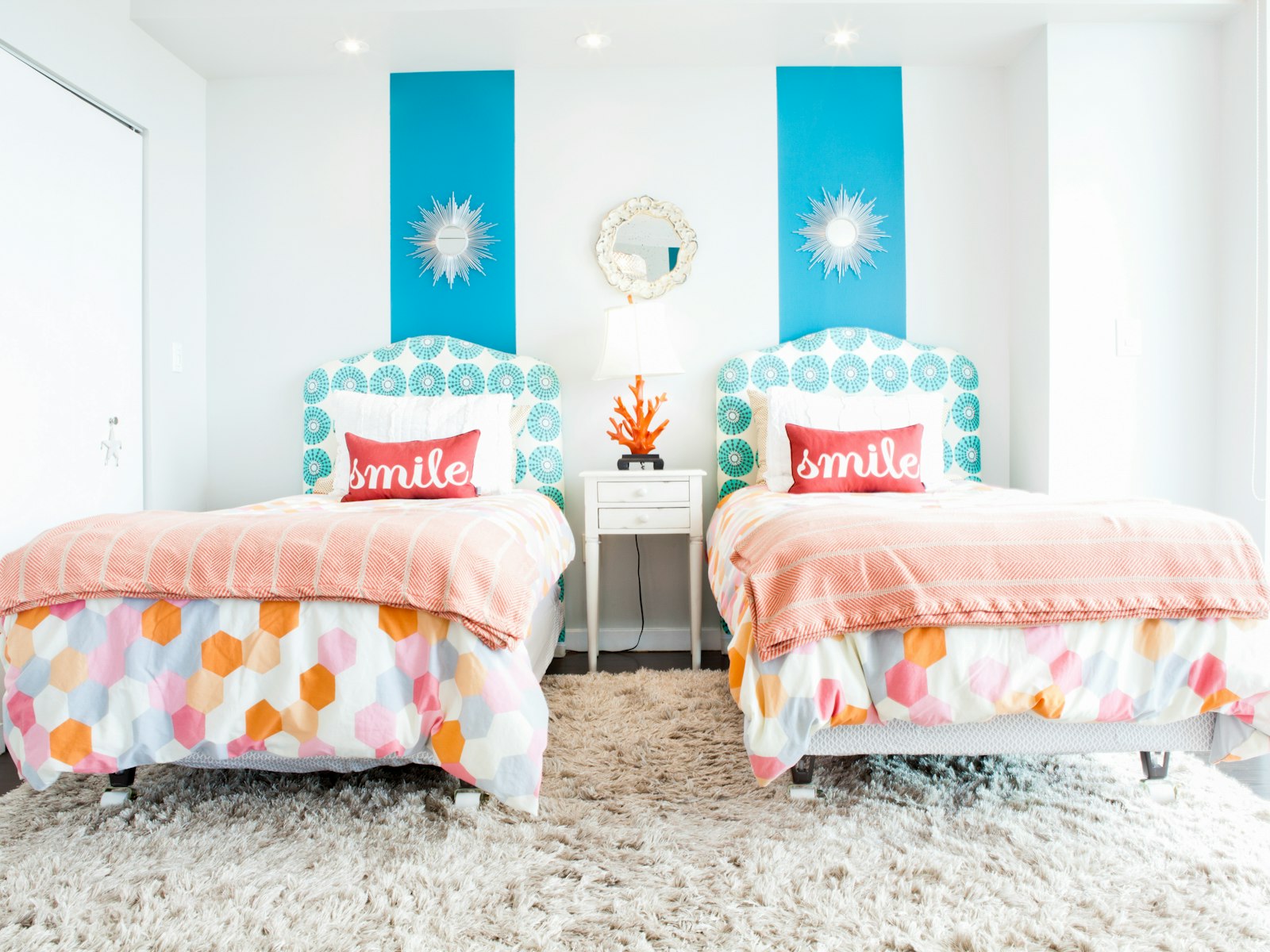 White and red throw pillows on floral bedding