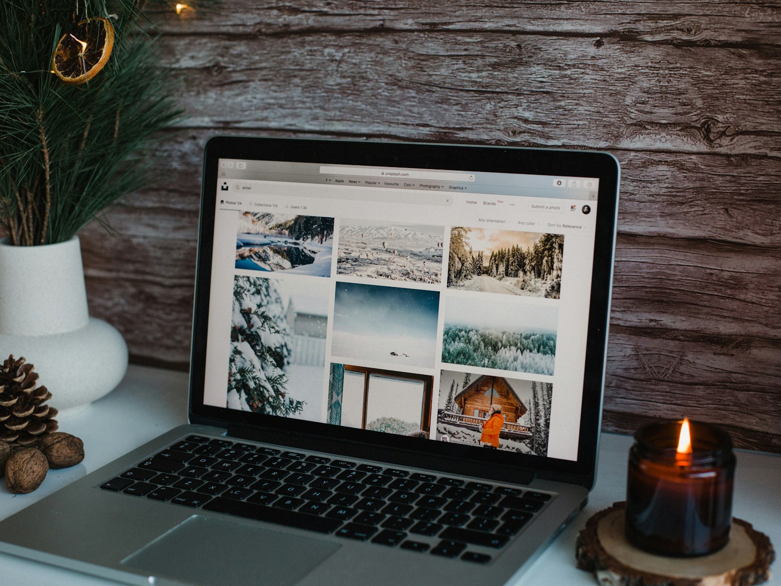 Macbook pro on brown wooden table – Christmas office decor idea