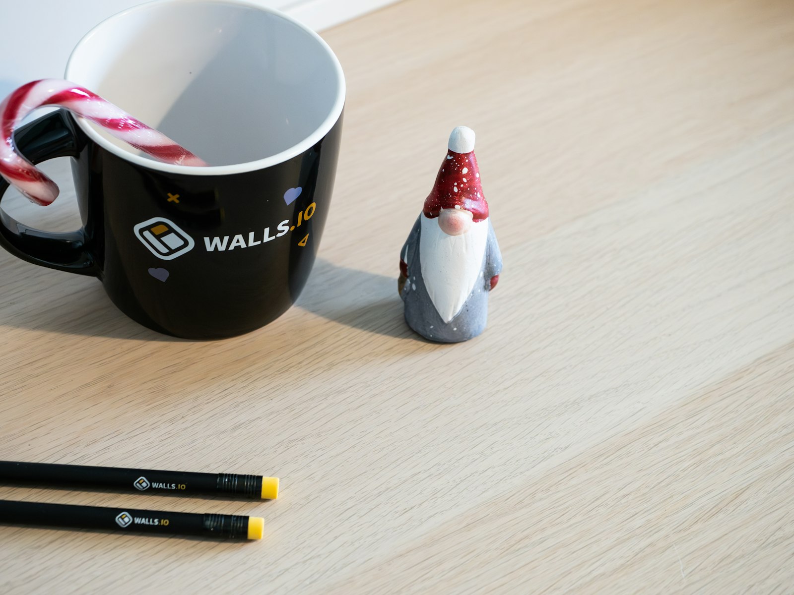 A coffee cup with a candy cane in it – Christmas office decor idea