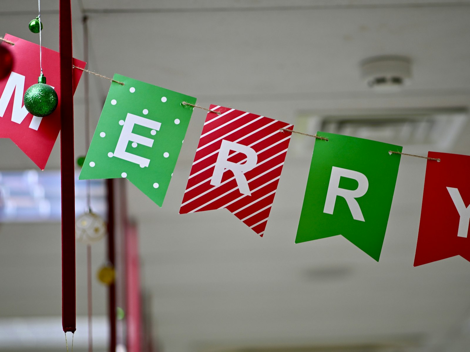 A banner spells out of flags that says merry christmas – Christmas office decor idea