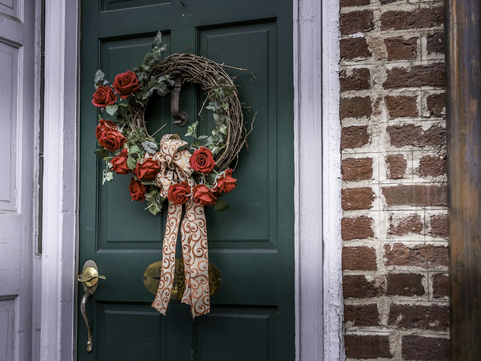 A green door with a wreath on it – Christmas outdoor decor idea