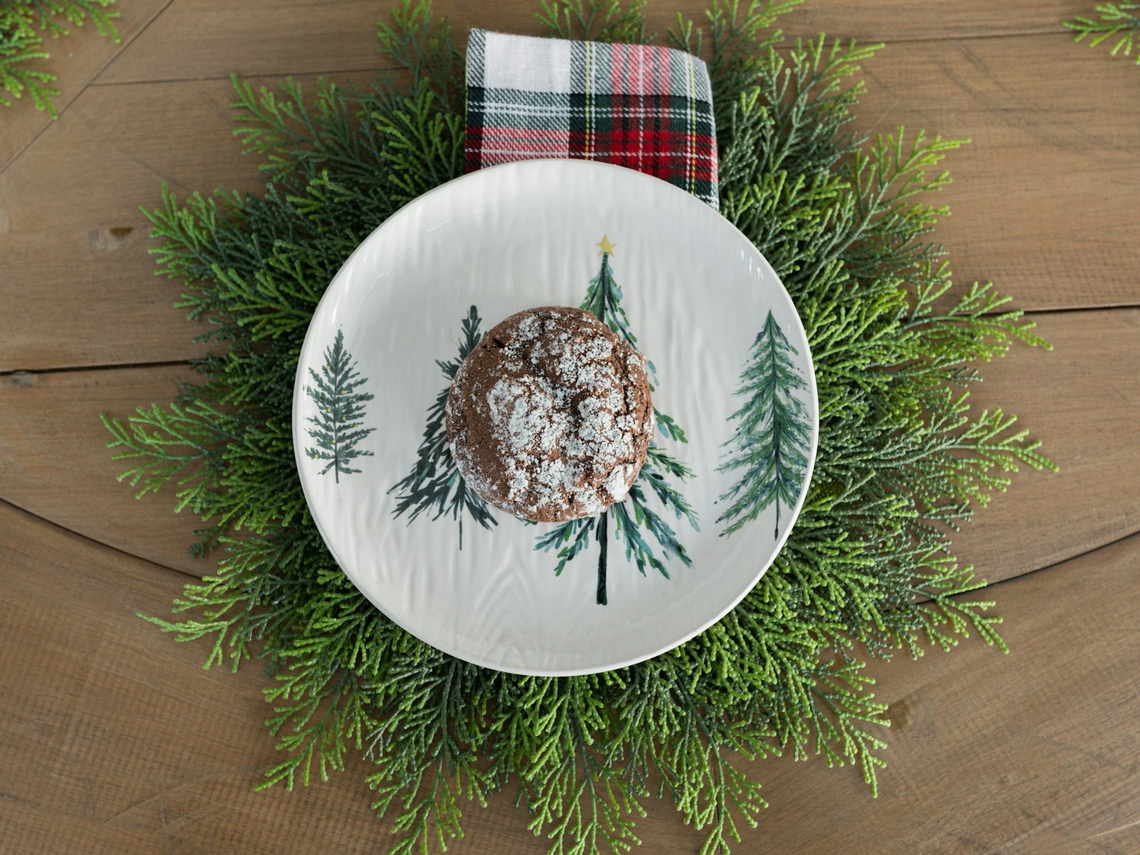 Christmas tree plate set on a ring of fresh greenery as a natural charger