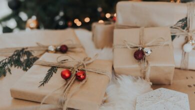 Kraft-wrapped Christmas gifts with ornaments and greenery