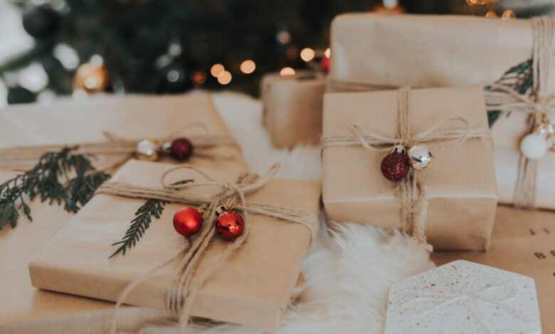 Kraft-wrapped Christmas gifts with ornaments and greenery