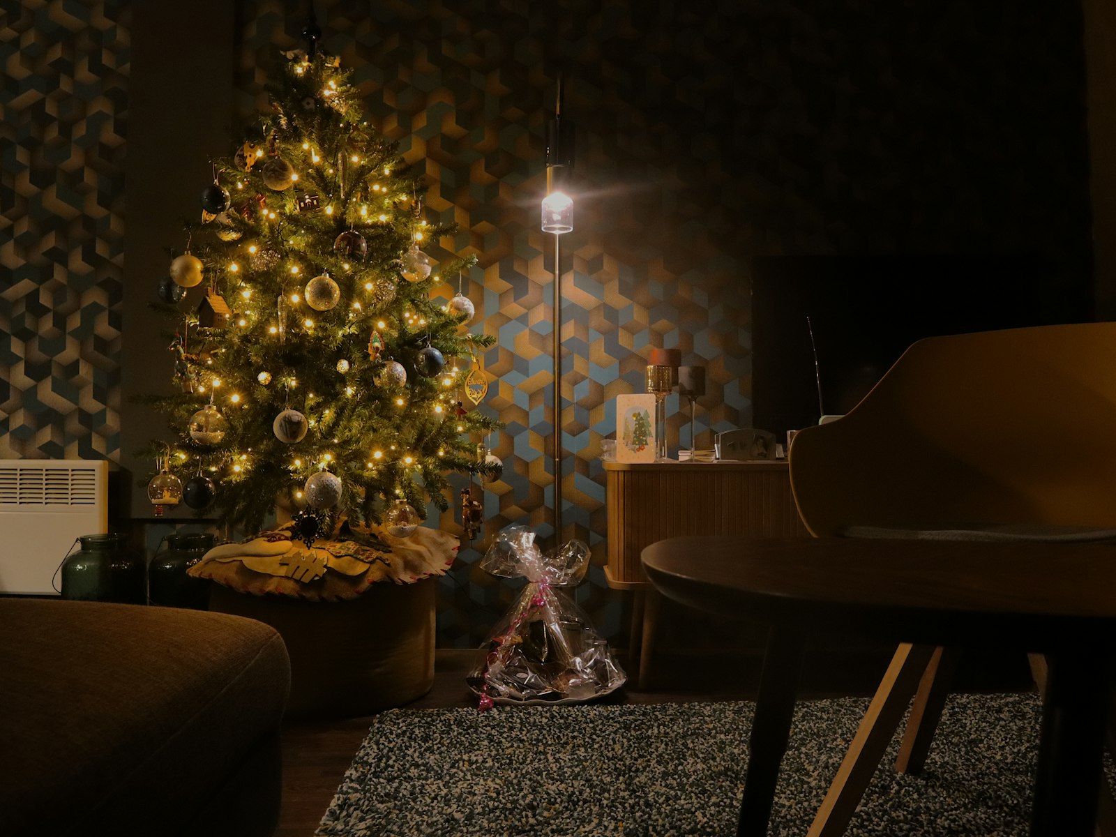 Cozy living room with a lit Christmas tree in the evening