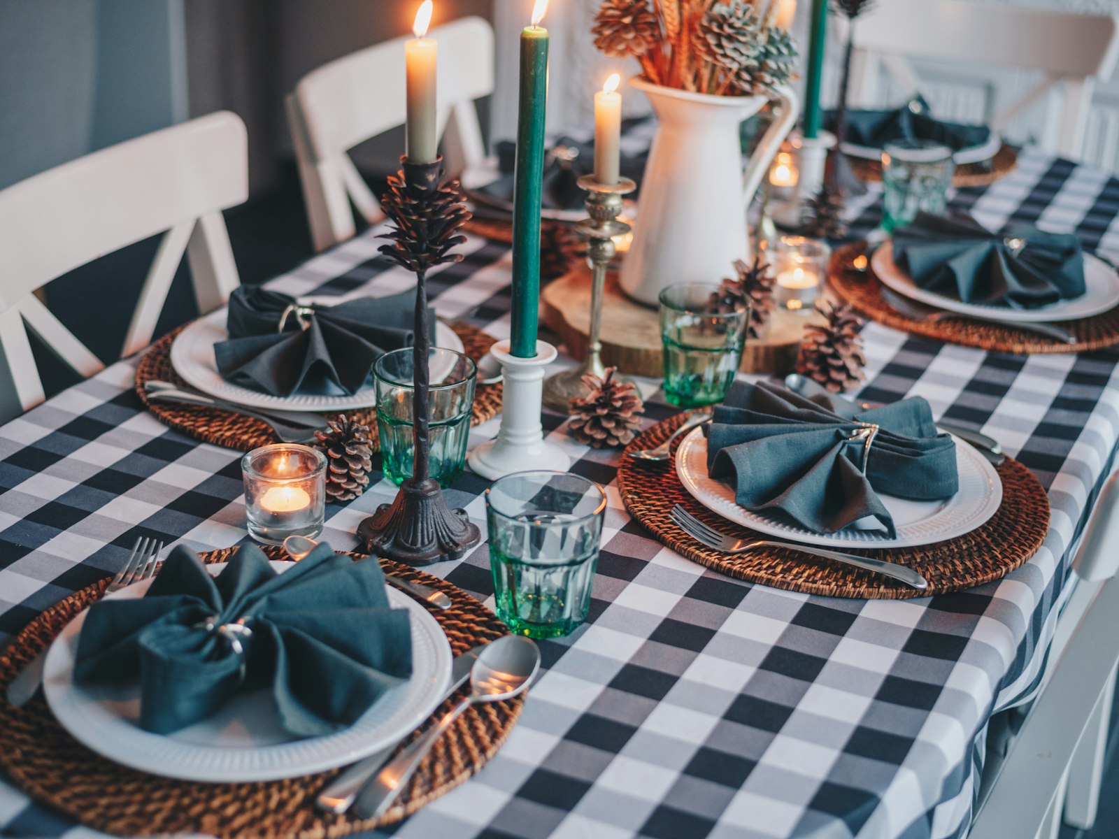 Blue gingham Christmas table with teal napkins, taper candles and glassware