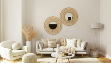 Neutral living room with round mirrors, boucle seating and a pampas vase
