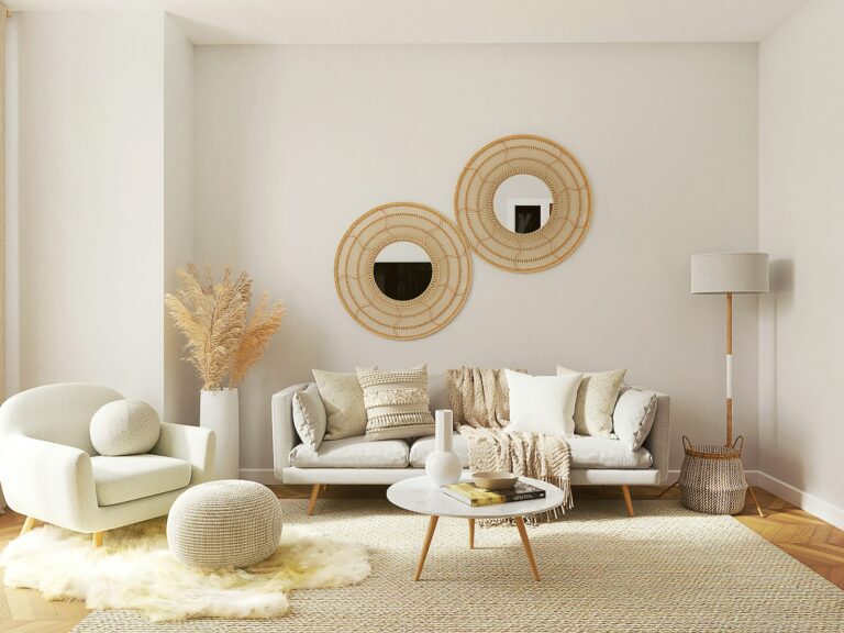 Neutral living room with round mirrors, boucle seating and a pampas vase