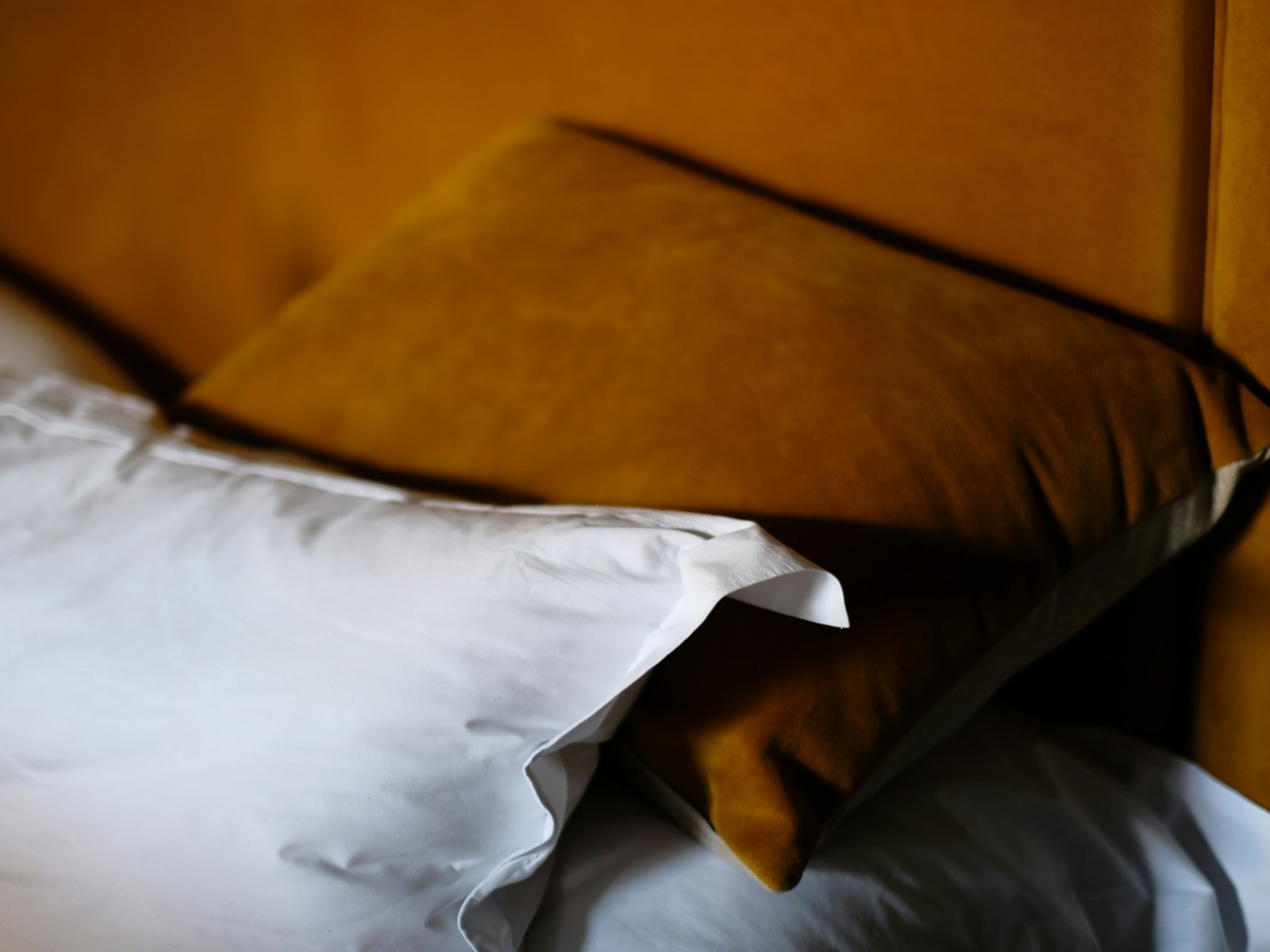 Soft pillows on a bed in warm afternoon light