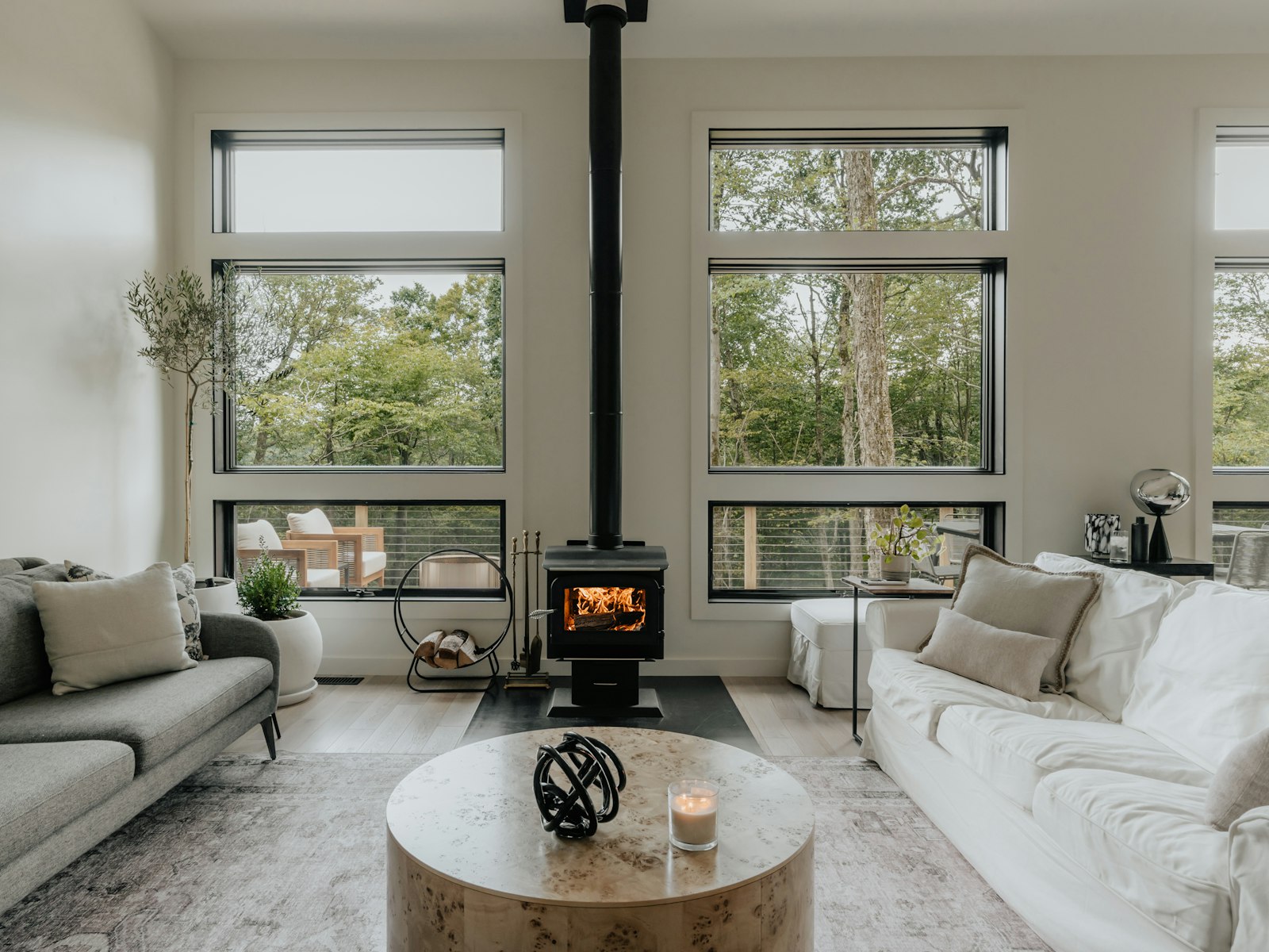 Scandinavian living room with a wood stove and neutral sofa