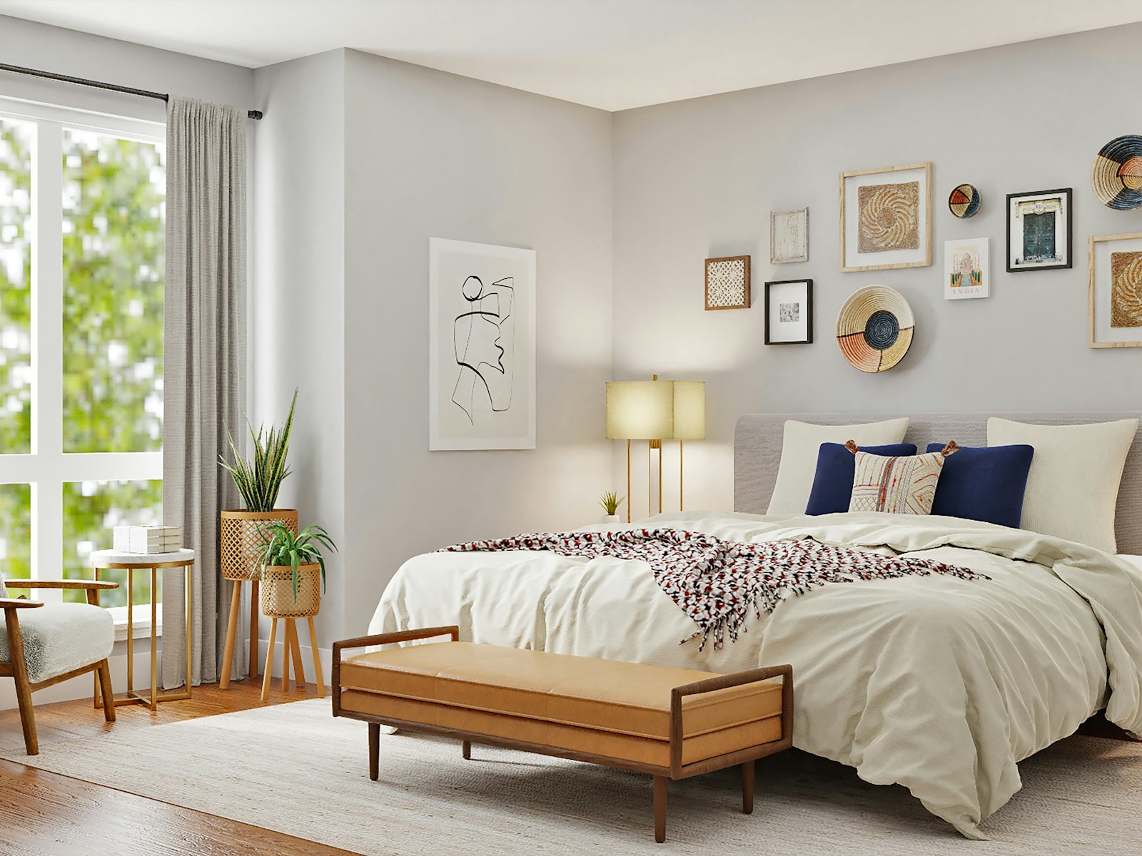 Bright bedroom with layered white bedding and a gallery wall