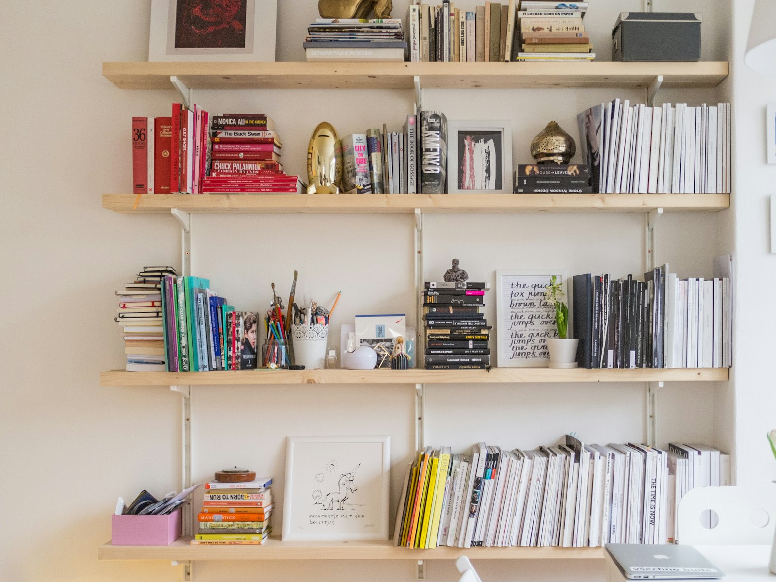 White bookshelf styled with books and small decor