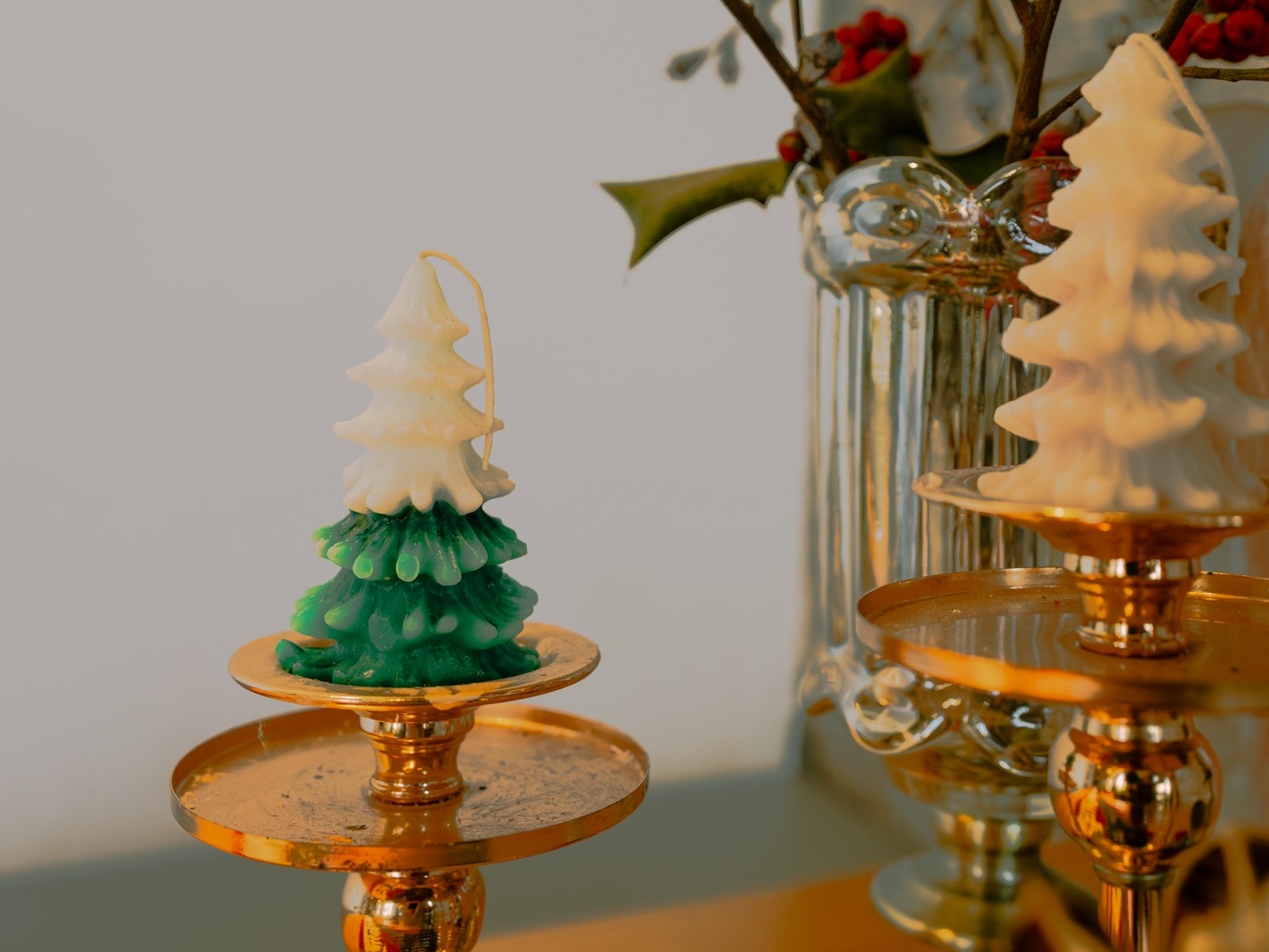 Mini ceramic Christmas trees on gold cake stands as a whimsical centerpiece