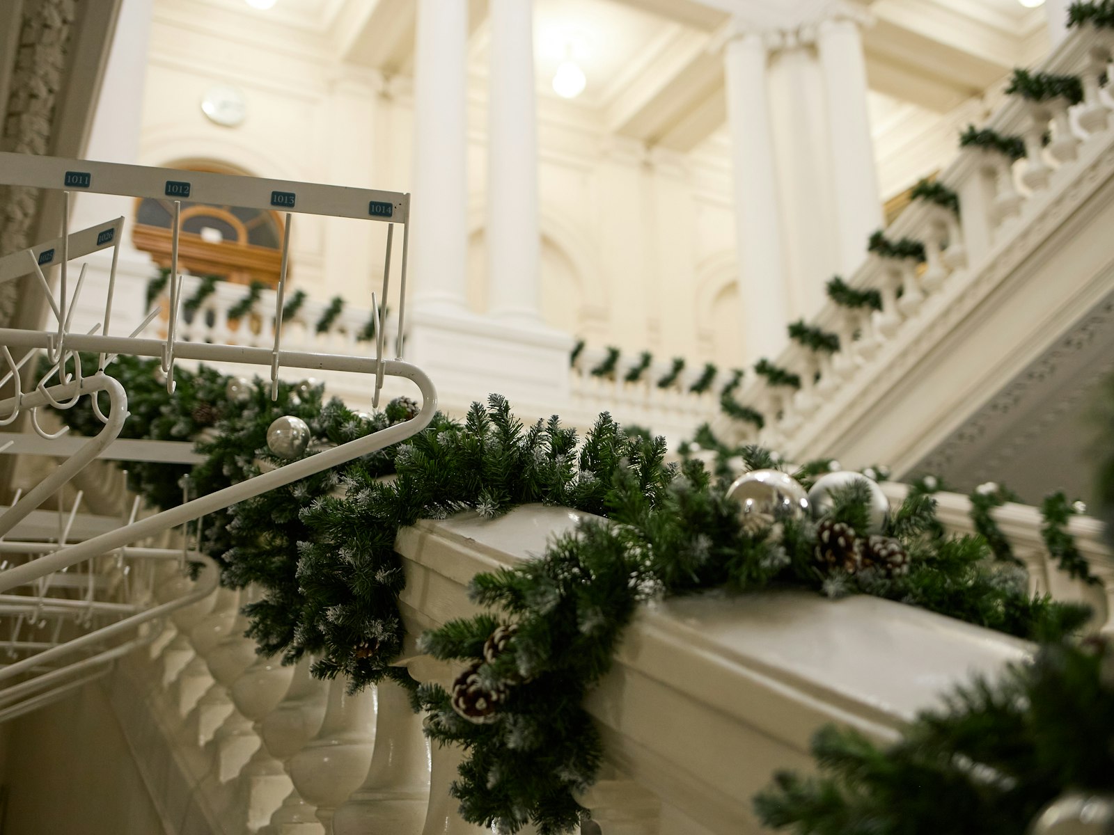 White staircase banister wrapped in a Christmas garland