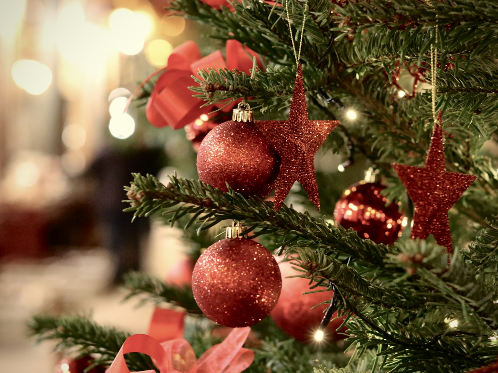 Traditional Christmas tree with red glitter ball ornaments and red stars